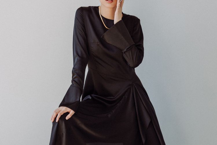 Woman in black dress posing